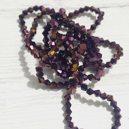 1x~110 metallic purple AB 4mm bicone beads